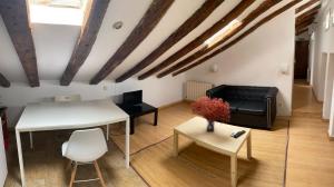 a living room with a table and a couch at COZY ROMANTIC MALASAÑA in Madrid