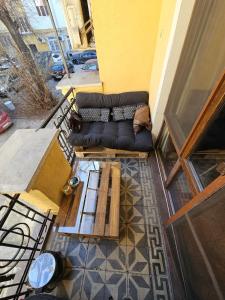 a living room with a couch and a table at Hot Spot 2bdrm apartment 1 in Sofia