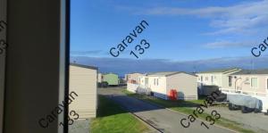 a view from a window of a row of houses at Caravan 133 snowdon summit 090 in Barmouth