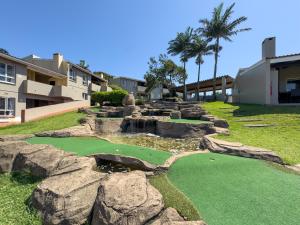a miniature golf course in a resort with rocks at 4 Chaka's Rocks Chalets - The Beach Cottage in Ballito
