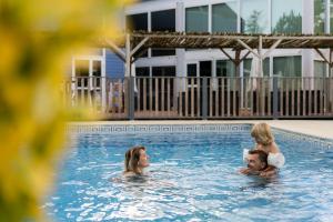a group of people swimming in a swimming pool at Camping La Pointe du Médoc in Le Verdon-sur-Mer