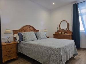 a bedroom with a bed and a mirror at Casa Balcon 2 bedroom by El Sirocco in Puerto de Mogán