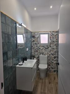 a bathroom with a toilet and a sink at Casa Balcon 2 bedroom by El Sirocco in Puerto de Mogán