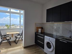 a kitchen with a sink and a washing machine at Casa Balcon 2 bedroom by El Sirocco in Puerto de Mogán +20 photos