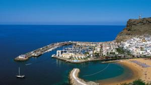 a group of boats in a harbor on a beach at Casa Balcon 2 bedroom by El Sirocco in Puerto de Mogán