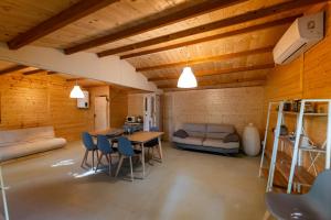 a living room with a table and chairs and a couch at Tiny House - Gilda e i suoi amici in Neive
