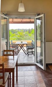 a room with a patio with tables and chairs at Mouse House in Gouvia