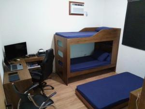 a room with a desk and a bed and a computer at Casa Andreza e Ramon in Paraty +12 photos