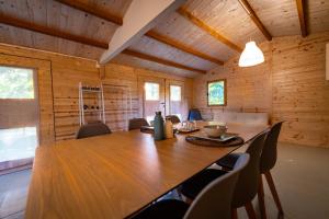 a dining room with a large wooden table and chairs at Tiny House - Gilda e i suoi amici in Neive