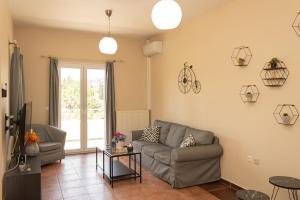 a living room with a couch and a table at Mouse House in Gouvia