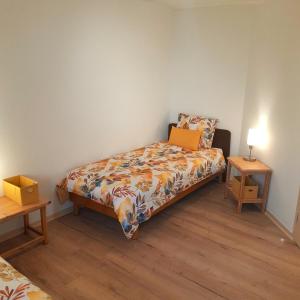 a small bedroom with a bed and a night stand at Gîte MANDRA chez gîtes QUE CANTA in Saint-Julien-Vocance +59 photos