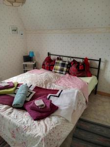 a bedroom with a bed with clothes on it at Hankas Biodling in Silverdalen