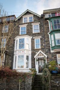a large brick house with a white front door at Luxury Pet Friendly 3 Bedroom Home with Copper Bath in Bowness-on-Windermere +31 photos