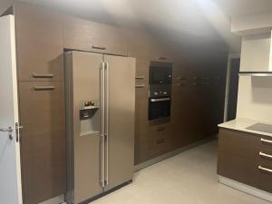 a kitchen with a stainless steel refrigerator and appliances at Luxor in Setúbal