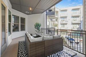 a porch with a couch on a balcony at Stylish 2BR Apartment, Near Galleria Dallas, Free Parking, Gym & Pool in Dallas +67 photos
