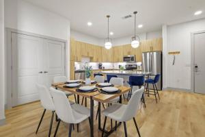 a kitchen and dining room with a table and chairs at Stylish 2BR Apartment, Near Galleria Dallas, Free Parking, Gym & Pool in Dallas