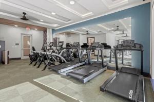 a gym with treadmills and ellipticals in a room at Stylish 2BR Apartment, Near Galleria Dallas, Free Parking, Gym & Pool in Dallas