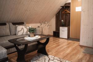 a living room with a table and a couch at Aare Accommodation in Valga