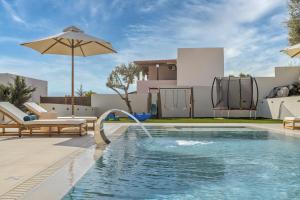 a swimming pool with a water slide in a backyard at Elysian Villas - With 2 Private Pools in Roumelí