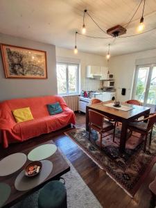 a living room with a couch and a table at Gite Charlotte au Domaine de la Morétie in Cublac