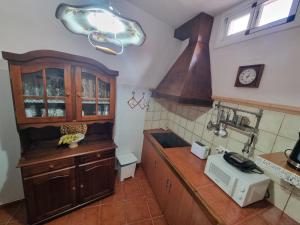 a kitchen with wooden cabinets and a counter top at Vivienda Vacacional Ca Na Paula in La Orotava +37 photos