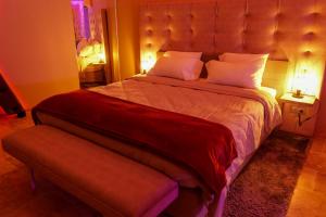 a bedroom with a large bed with a large headboard at Loveroom de charme avec jacuzzi et sauna in La Penne-sur-Huveaune
