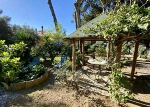 - un jardin avec une table et des chaises ainsi qu'un pavillon dans l'établissement Casa Nora, à Castiglioncello