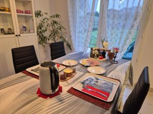 a dining room table with a meal on it at Chez Ninie in Le Cloître-Saint-Thégonnec +14 photos