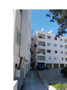 an apartment building with a green arrow pointing to it at Mediterranean Apartments 1 in Paphos City