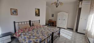 a bedroom with a bed and a door at Casa GATO GORDO in Assemini