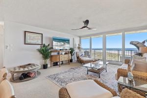 a living room with a view of the ocean at Inlet at Minorca 904 in New Smyrna Beach