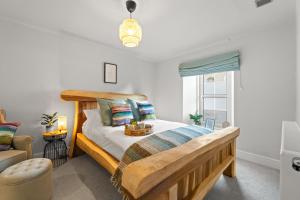 a bedroom with a wooden bed and a window at Tweedside in Innerleithen