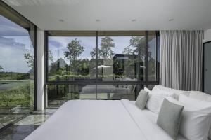 a white bed in a room with a large window at Villa Onyx in Amphoe Koh Samui +29 photos