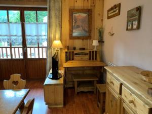 a kitchen with a table and a desk with a microwave at Charmant 3 Pièces pour 8 avec Balcon et Piscine à Vignec, près de Saint-Lary-Soulan - FR-1-504-27 in Vignec