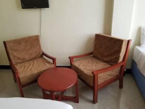 two chairs and a table in a room at KiliCrane Lodge Arusha in Arusha