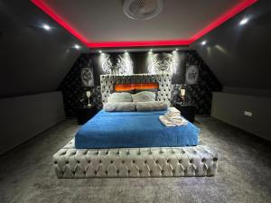 a bedroom with a large bed with a blue blanket at Traumhaftes Ferienhaus Inkl Whirlpool und Sauna in Viersen +32 photos