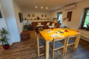 a dining room and living room with a yellow table and chairs at UpArt Bled in Bled