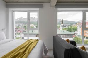 a bedroom with a bed and a large window at Casa Cima in Ushuaia