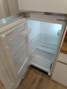 an empty refrigerator with its door open in a kitchen at Zovetto Holidays in Genova +34 photos