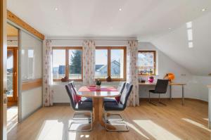 a dining room with a table and chairs at Haus am Ettenberg in Frickingen