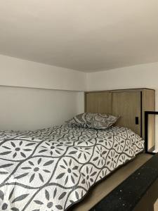 a bedroom with a bed with a comforter at Apartment in La Castellana in Bogotá