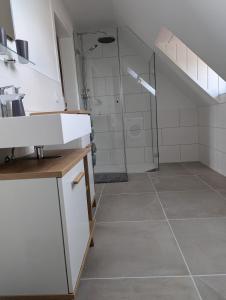a bathroom with a shower and a tile floor at Ferienwohnung Alte Bäckerei in Meißen