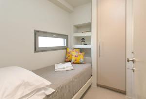 a small bedroom with a bed and a window at Summer Sense, New Private Retreat with Private Pool, Agia Anna, Naxos in Agia Anna