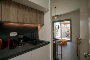 a kitchen with a sink and a counter top at Summer Sense, New Private Retreat with Private Pool, Agia Anna, Naxos in Agia Anna
