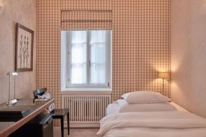 Uma cama ou camas num quarto em Hotel Kindli