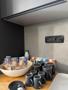 a counter top with a bowl of food and cups at Casa Cecilia, Natura & Relax in Villanova dʼAsti