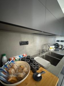 a kitchen counter with a sink and a bowl of food at Casa Cecilia, Natura & Relax in Villanova dʼAsti