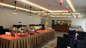 a long table in a room with tables and chairs at soluxe hotel cotonu in Cotonou
