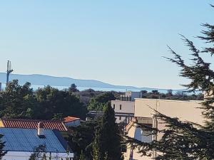 a view of a city with mountains in the background at Apartment Mare D with a pool new in Novalja