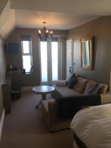 a living room with a couch and a table at The White House Hotel in Newquay